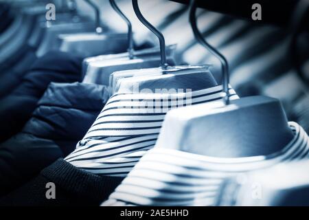 Selective focus winter coats hanged on a clothes rack. Stock Photo