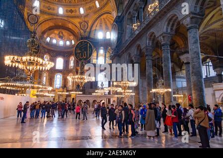 Tourists inside Hagia Sophia, former Orthodox cathedral and Ottoman imperial mosque, in Istanbul, Turkey Stock Photo