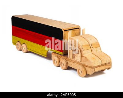 Close-up of a wooden toy truck with a painted national flag Germany. The concept of export-import,transportation, national delivery of goods Stock Photo