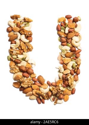 Letter U of the English alphabet from a mixture of hazelnuts, almonds, walnuts, peanuts, cashews, pumpkin seeds on a white isolated background. Food p Stock Photo