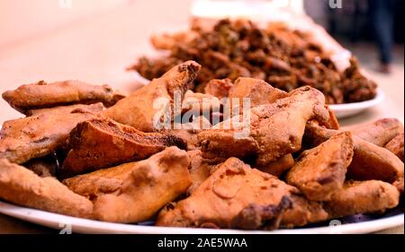 Crispy onion bhajis or kanda or pyaj ke pakore or pakoda , delicisous indian and brazilian street food on salad, typically enjoyed in rainy / monsoon Stock Photo