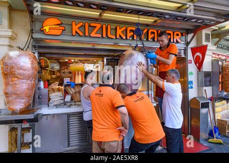 People trying to set the meat for a Kebab shop in Istanbul, Turkey Stock Photo