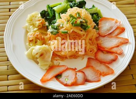 dried thin rice noodle topping barbecue pork and dumpling on dish Stock Photo