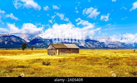 An abandoned Barn at Mormon Row with in the background cloud covered Peaks of the Grand Tetons In Grand Tetons National Park near Jackson Hole, WY USA Stock Photo