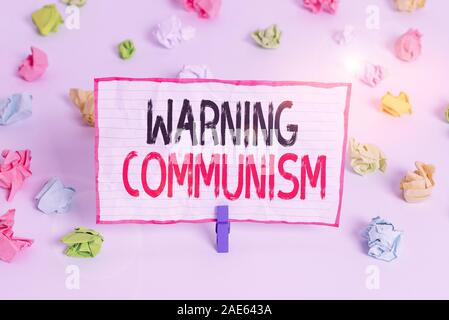 Handwriting text writing Warning Communism. Conceptual photo economic system where the group owns the production Colored crumpled papers empty reminde Stock Photo