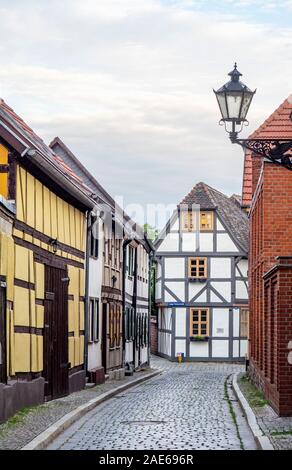 Cobblestobe street and timber frame buildings in historic Altstadt Tangermünde Saxony-Anhalt Germany.