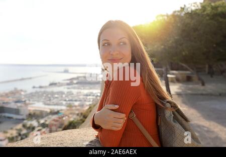 Pretty young tourist girl relaxing enjoying travel in Europe at sunset. Stock Photo