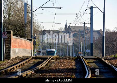 A Nottingham Tram on the tracks at the bottom of a steep gradient,Wilkinson Street,Nottingham,England,UK Stock Photo