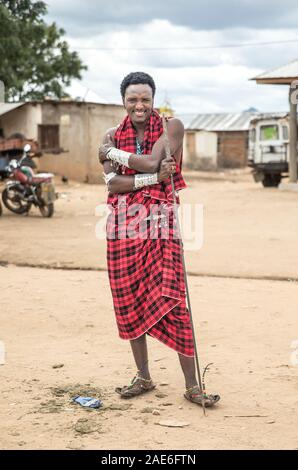 handsome maasai warrior with his spear in a local town Stock Photo