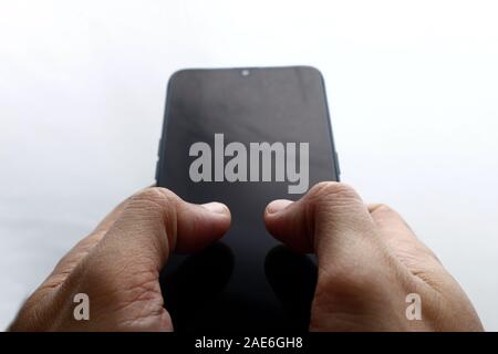 Photo of human hand holding a smartphone on white background Stock Photo