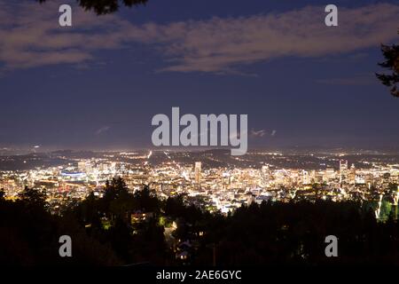 Illuminated Portland, Oregon urban cityscape skyline at night seen from Pittock Mansion in summertime. Stock Photo