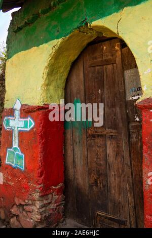 Ethiopia, Amhara Region, Gondar, town centre, old wooden gate of Tekla Haimonot’s Orthodox Church, with colourfully painted gatehouse Stock Photo