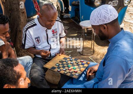 Ethiopia, Amhara Region, Gondar, Arada Market, Christian and Moslem men playing draughts using beer bottle tops Stock Photo