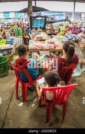Local people looking on the tv in the market, Pakse, Laos, Asia Stock Photo