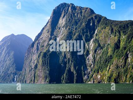 Stirling Falls and The Lion rock, amid spectacular fiord scenery in Milford Sound, Fiordland National Park, New Zealand. Stock Photo
