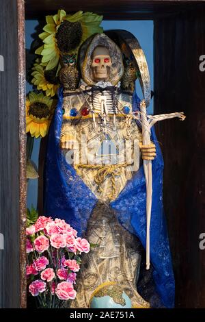 A Santa Muerte statue in the home temple of a Mexican American devotee in Elmhurst, Queens, New York City Stock Photo