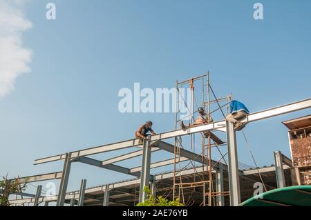 workers on top a metallic structure, construction site, Bali Stock Photo