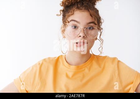 Perplexed troubled cute ginger girl trying solve problematic situation standing worried biting lip nervously face complex complicated work, standing Stock Photo