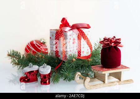 Christmas composition with decorations, gift boxes, baubles, boots and sleigh of Santa Claus. on white background. Christmas holidays background Stock Photo