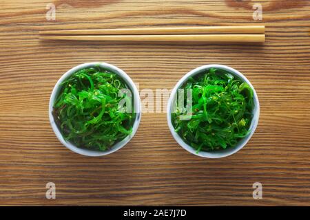 Two Small Bowls Of Goma Wakame On A Wooden Background Stock Photo