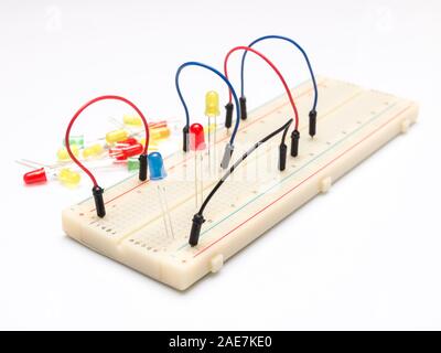 LEDs and cables on prototype table isolated on white background Stock Photo