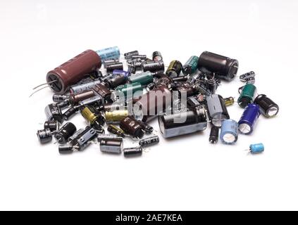 Old electrolitics capacitors isolated in white background selective focus. Recycling concept Stock Photo