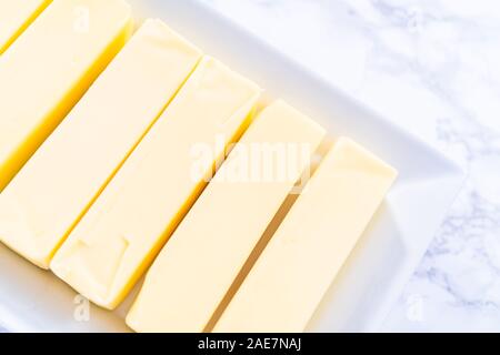 Organic sticks of butter at the room temperature. Stock Photo