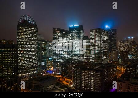 Aerial drone night shot of Skyscrapers with lights on in La Defense, financial district of Paris Stock Photo