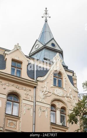 Riga Art Nouveau (Jugendstil), fragment of house on Antonijas Street, mansard, roof tower, many stucco decorations Stock Photo