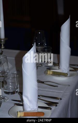 white festive table setting with candles and noble cloth napkins, wedding table setting Stock Photo