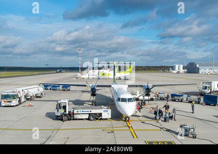 RIGA - OCT 10: Airplane with Passengers at Airport in Riga on October 10. 2017 in Latvia Stock Photo