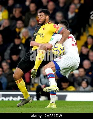 Watford's Troy Deeney and Crystal Palace's Martin Kelly (right) battle for the ball during the Premier League match at Vicarage Road, Watford.