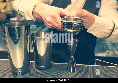 Bartender is squeezing citrus juice, toned Stock Photo