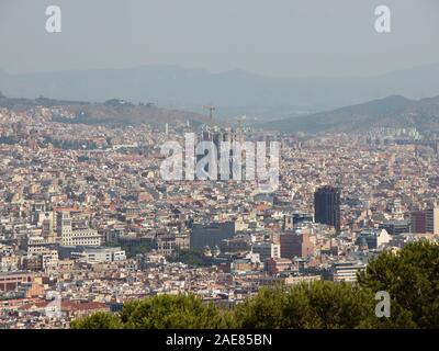 Mountain Panoramic View with Sagrada Familia Barcelona in Background. Smog is hiding the mountains. Stock Photo