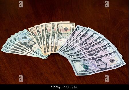 Fan of American (US) money with five, ten & twenty dollar bills featuring US presidents, Abraham Lincoln, Alexander Hamilton & Andrew Jackson Stock Photo