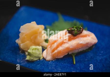 Salmon belly sushi set with lowlighting darkshadow and low aperture depth of field style. Stock Photo