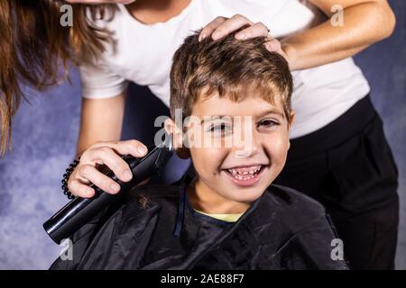 Little boy getting a haircut with a cutting machine Stock Photo