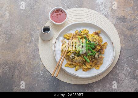 Oyster Omelette with hot suace singaporean cuisine, copy space. Stock Photo