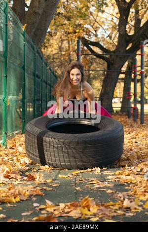 young sports woman does gymnastics on the autumn sports ground Stock Photo