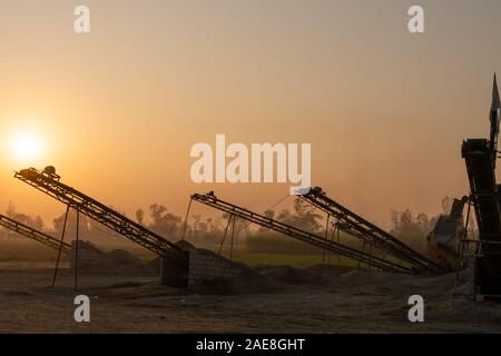 Silhouette of Stone crusher plant conveyor belt Stock Photo