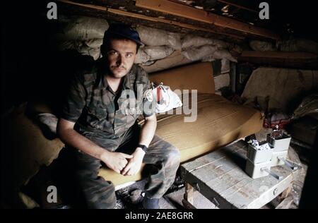 11th August 1993 During the Siege of Sarajevo: a Bosnian-Serb soldier inside his bunker on Mount Trebevic, above Sarajevo. He wears the shoulder patch of the Serb Volunteer Guard (Srpska dobrovoljačka garda or SDG), also known as Arkan’s Tigers. Stock Photo