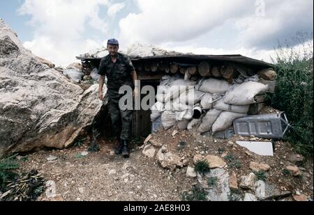 11th August 1993 During the Siege of Sarajevo: a Bosnian-Serb soldier exits his bunker on Mount Trebevic, above Sarajevo. He wears the shoulder patch of the Serb Volunteer Guard (Srpska dobrovoljačka garda or SDG), also known as Arkan’s Tigers. Stock Photo