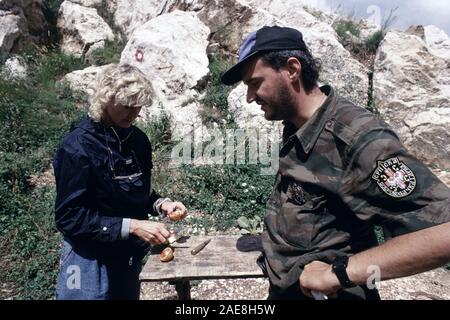 11th August 1993 During the Siege of Sarajevo: Hilary Brown (ABC News correspondent) with a Bosnian-Serb soldier outside his bunker on Mount Trebevic, above Sarajevo. He wears the shoulder patch of the Serb Volunteer Guard (Srpska dobrovoljačka garda or SDG), also known as Arkan’s Tigers. Stock Photo