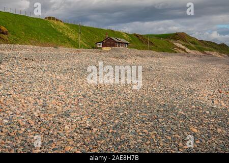 Nethertown, Cumbria, England, UK - May 02, 2019: The pebble beach and a house at the beach Stock Photo
