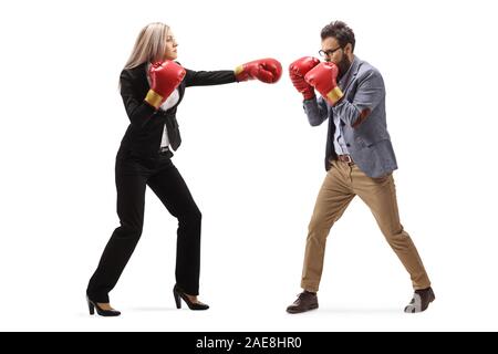 Full length profile shot of a man and woman in formal clothes fighting with boxing gloves isolated on white background Stock Photo