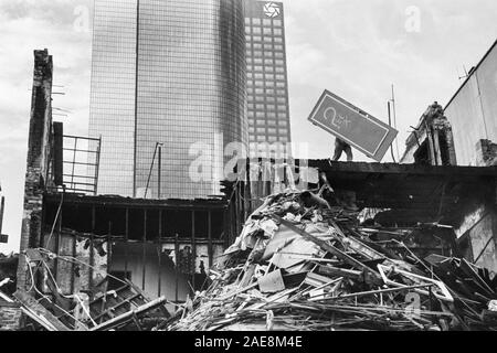 Los Angeles, California, USA - 1988:  Archival black and white editorial view of demolition worker throwing door off building on Hill Street. Stock Photo