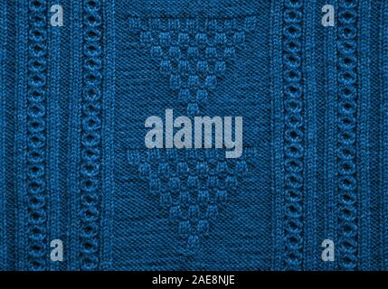 Texture of handmade knitted blue sweater for cozy holiday. Christmas background. Trendy color of the 2020. Stock Photo