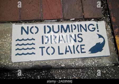 rainwater drain with no dumping drains to lake sign on sidewalk kissimmee florida usa Stock Photo