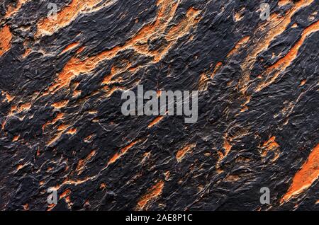 Black with orange spots seamless venetian stucco. Background and texture of decorative plaster. Stock Photo