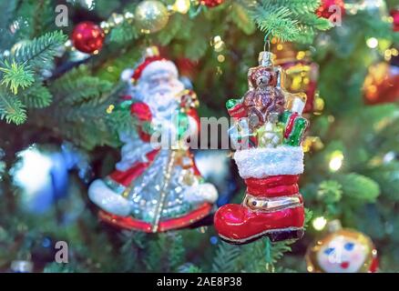 Glass Christmas tree toy - red boot Santa Claus's with gifts. Christmas decor in vintage style. Stock Photo